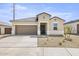 Charming single-story home with a two-car garage and desert landscaping at 23957 W Papago St, Buckeye, AZ 85326