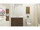 Bathroom with a brown vanity, white countertop, modern fixtures, and coordinated decor elements at 25121 N 174Th Ln, Surprise, AZ 85387