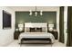 Relaxing main bedroom with an elegant green accent wall and stylish furnishings at 25121 N 174Th Ln, Surprise, AZ 85387