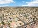 Wide aerial view of community featuring many single-story homes with desert landscaping, pools, and a city view at 2520 W Minton St, Phoenix, AZ 85041