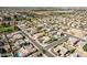 A sprawling aerial view of a residential neighborhood with lush green landscaping, pools, and tile-roofed homes at 2520 W Minton St, Phoenix, AZ 85041