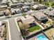 Community aerial view, single-story home featuring desert landscaping, tile roof, green lawn, pool, covered patio at 2520 W Minton St, Phoenix, AZ 85041