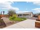 A serene backyard features desert landscaping, a lawn, and a covered patio perfect for entertaining at 2520 W Minton St, Phoenix, AZ 85041