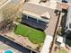 Aerial view of private backyard with healthy green lawn, desert landscaping, hot tub, and covered patio at 2520 W Minton St, Phoenix, AZ 85041