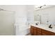 Bright bathroom featuring a glass enclosed shower, a soaking tub, and double vanity sinks at 2520 W Minton St, Phoenix, AZ 85041