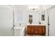 Bright bathroom featuring a glass enclosed shower, a soaking tub, and double vanity sinks at 2520 W Minton St, Phoenix, AZ 85041