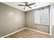 Bedroom with ceiling fan, wood-look tile flooring, and a window with blinds at 2520 W Minton St, Phoenix, AZ 85041