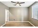 Spacious bedroom with wood-look flooring, ceiling fan, and natural light from window at 2520 W Minton St, Phoenix, AZ 85041