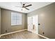 Neutral bedroom featuring wood-look flooring, ceiling fan, and a view into the en-suite at 2520 W Minton St, Phoenix, AZ 85041