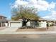 A charming single-story home with desert landscaping and a shade tree offers curb appeal at 2520 W Minton St, Phoenix, AZ 85041