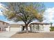 Inviting single-story home with desert landscaping and a spacious driveway leading to a three-car garage at 2520 W Minton St, Phoenix, AZ 85041