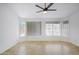 Bright living room features tile floors, ceiling fan, and large windows letting in natural light at 2520 W Minton St, Phoenix, AZ 85041