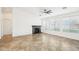 Bright living room with a stone fireplace, neutral tile flooring, and lots of natural light at 2520 W Minton St, Phoenix, AZ 85041