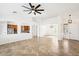 Open-concept living space showcasing neutral tile flooring, recessed lighting, and seamless flow to the kitchen at 2520 W Minton St, Phoenix, AZ 85041