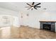 Spacious living room featuring tile flooring, a modern ceiling fan, and an elegant fireplace at 2520 W Minton St, Phoenix, AZ 85041