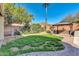 Lush backyard with a gazebo, mature trees, and a grass lawn at 2738 W Silver Fox Way, Phoenix, AZ 85045