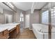 Bright bathroom featuring double sinks, separate tub and shower, and tile flooring at 2738 W Silver Fox Way, Phoenix, AZ 85045