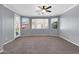 Bedroom with carpet floor, neutral walls, many windows and doors, and a ceiling fan at 2738 W Silver Fox Way, Phoenix, AZ 85045