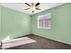 Bedroom with light green walls, neutral carpet, and lighted ceiling fan at 2738 W Silver Fox Way, Phoenix, AZ 85045