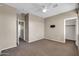 Bedroom features carpet flooring, neutral walls, ceiling fan, and multiple doorways to other areas at 2738 W Silver Fox Way, Phoenix, AZ 85045