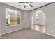 Cozy bedroom with soft carpet and a large window with natural light at 2738 W Silver Fox Way, Phoenix, AZ 85045