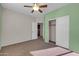 Bedroom with light green accent wall, closet, and neutral colored carpet at 2738 W Silver Fox Way, Phoenix, AZ 85045