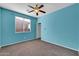 Bedroom with light blue walls, neutral carpet, window, and lighted ceiling fan at 2738 W Silver Fox Way, Phoenix, AZ 85045