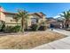 A suburban home with a landscaped front yard featuring mature palm trees and flowering shrubs at 2738 W Silver Fox Way, Phoenix, AZ 85045