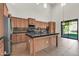 This kitchen showcases an island, tile floor, stainless steel appliances, light-colored cabinetry, and a vaulted ceiling at 2738 W Silver Fox Way, Phoenix, AZ 85045