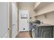 Bright laundry room with a tile floor, and a washer and dryer set at 2738 W Silver Fox Way, Phoenix, AZ 85045