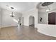 Large, open-concept living room featuring stylish lighting, archways, and tile floors at 2738 W Silver Fox Way, Phoenix, AZ 85045