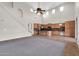 Bright living space featuring a kitchen, grand staircase, and high ceilings with clerestory windows at 2738 W Silver Fox Way, Phoenix, AZ 85045