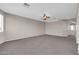 Open living room features neutral walls, carpet, and a ceiling fan at 2738 W Silver Fox Way, Phoenix, AZ 85045