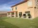 Large backyard with green lawn and a covered patio, ideal for outdoor entertaining at 3145 W Sandra Ter, Phoenix, AZ 85053