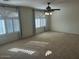 Spacious bedroom featuring carpet flooring, multiple windows with blinds and curtains, and a ceiling fan with lights at 3145 W Sandra Ter, Phoenix, AZ 85053