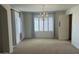 Well-lit dining room with contemporary chandelier, large window, and neutral walls at 3145 W Sandra Ter, Phoenix, AZ 85053