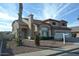 Charming two-story home featuring a three car garage, arched entryway, and neutral desert landscaping at 3145 W Sandra Ter, Phoenix, AZ 85053