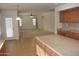 Open concept kitchen with an island, flowing seamlessly into the living area, promoting social interaction and connectivity at 3145 W Sandra Ter, Phoenix, AZ 85053