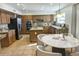 Spacious kitchen featuring an island, tile floors, and a dining area, creating a welcoming space for meals at 3145 W Sandra Ter, Phoenix, AZ 85053