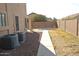 Low maintenance side yard with stone groundcover and a paved walkway at 3145 W Sandra Ter, Phoenix, AZ 85053