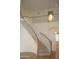 Elegant staircase with carpeted steps, wooden railing, and natural light from nearby windows at 3145 W Sandra Ter, Phoenix, AZ 85053