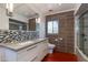 Contemporary bathroom with modern vanity, dual sinks, stone counters, mosaic backsplash and decorative mirror at 3237 E Meadowbrook Ave, Phoenix, AZ 85018