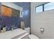 Modern bathroom with a mirrored cabinet, colorful mosaic tiles, and sleek sink at 3237 E Meadowbrook Ave, Phoenix, AZ 85018