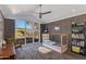 Brightly lit bedroom with large picture window, light-colored walls and trim and carpeted floors at 3237 E Meadowbrook Ave, Phoenix, AZ 85018