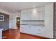 Bright utility room with ample white storage cabinets and view into adjacent room at 3237 E Meadowbrook Ave, Phoenix, AZ 85018