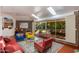 Bright living room featuring mid-century modern furniture, concrete accent wall and access to a large outdoor space at 3237 E Meadowbrook Ave, Phoenix, AZ 85018