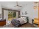 A bedroom with brick feature wall and sliding door access to the outside at 3237 E Meadowbrook Ave, Phoenix, AZ 85018