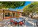 Charming backyard patio area with citrus trees, shade, table and chairs at 3237 E Meadowbrook Ave, Phoenix, AZ 85018