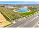 Overhead view of a community lake surrounded by paved roads, walkways, and landscaped areas near the neighborhood buildings at 3548 E Mesquite St, Gilbert, AZ 85296