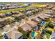 An aerial view of a residential neighborhood showcasing homes, streets, and community amenities at 3548 E Mesquite St, Gilbert, AZ 85296